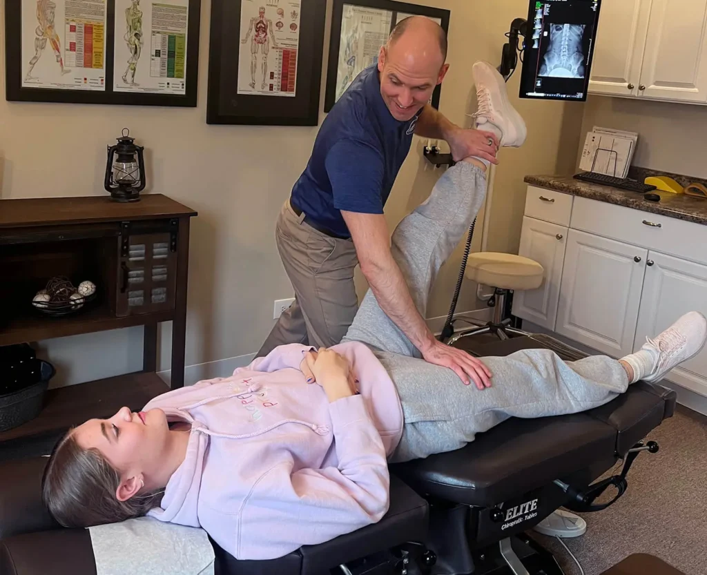 Dr. Nate performing knee pain treatment on a patient in Arlington Heights